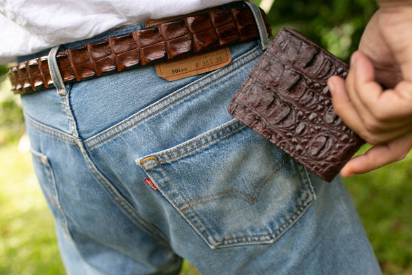 a men showing his crocodile skin wallet and also showcasing his Australian saltwater crocodile skin belt