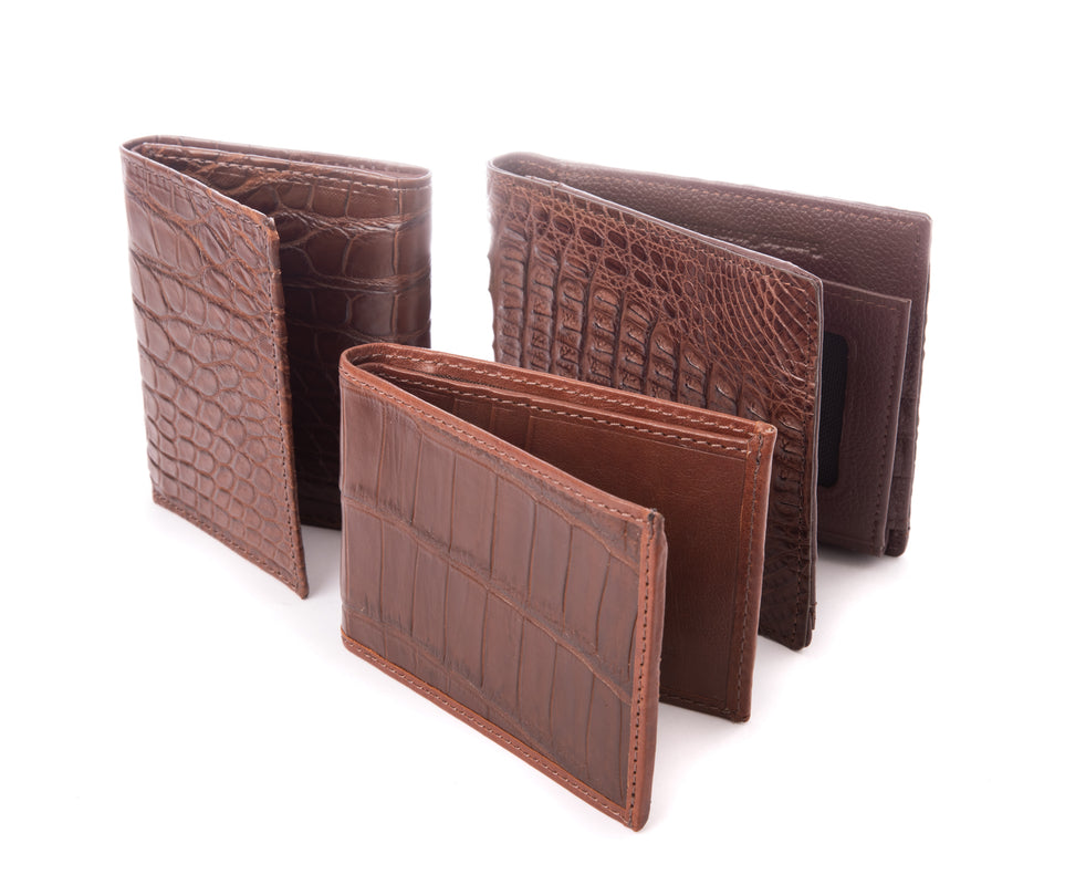 3 different crocodile skin wallets with bi-fold and tri-fold designs.