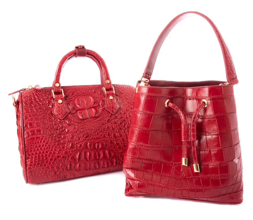 2 red crocodile skin handbags